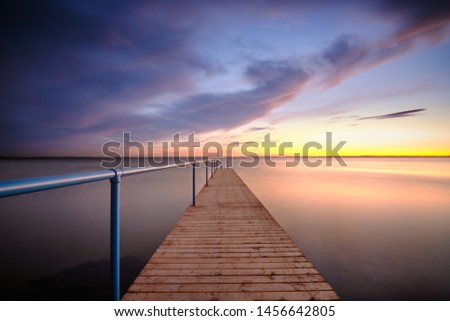 Rydebäck small pier with blue hand rail at sunset