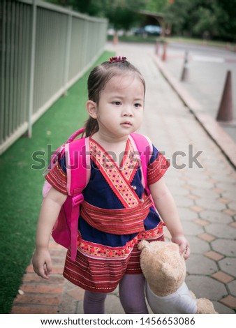 Asia baby girl Child carrying bag.