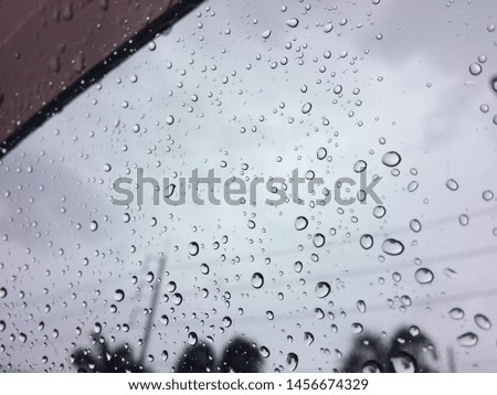 Rain drops on window sureface glasses car