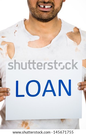 A close-up cropped image of a homeless man in poor clothing holding a sign which says loan. Isolated on a white background. Financial crisis, poor economy. Housing bubble. Bank system crisis 