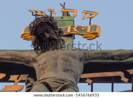 Jesus Christ Statue on the bridge in Europe. The body of Christ on the cross. Crown of thorns on the head of Jesus.
