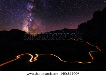 Night mountain road. Night sky with milky way and stars.