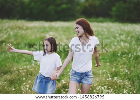 mother and daughter holding hands walk fun joy leisure