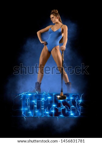 Fitness poster.  Sporty girl with a sledgehammer on smoke background - Image
