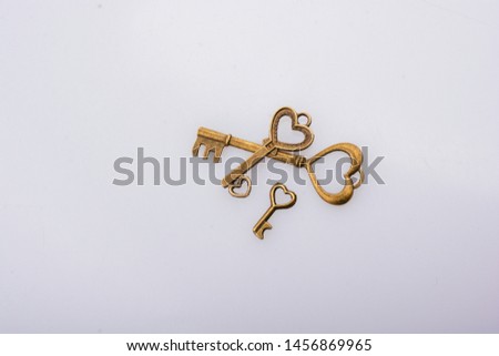 Heart shaped retro metal keys on white background