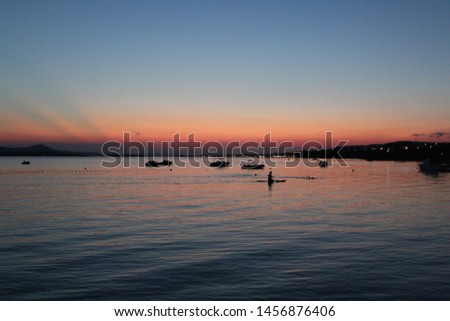 Sunset on the sea with a paddler, biograd na moru