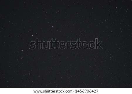 Night sky low light photo. A lot of stars and constellations on dark sky. Stock photo of deep sky. Far away from city and no clouds.