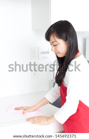 young housewife cleaning kitchen, isolated on white background 