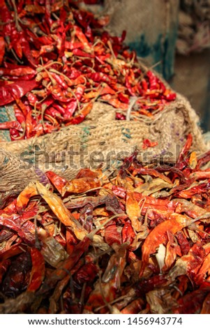 Burlap bag filled with red chili peppers in market of Delhi, India
