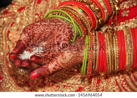 Indian wedding hands holding bride and grooms. Indian culture marriage bride hand with beautiful red bangle. ring ceremony before marriage.  