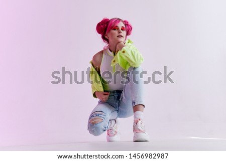 stylish woman with pink hair in a green jacket
