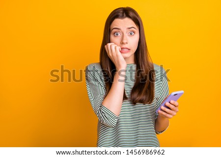 Photo of worried concerned girlfriend seeing her phone screen cracked and shattered to pieces while isolated with yellow background Royalty-Free Stock Photo #1456986962