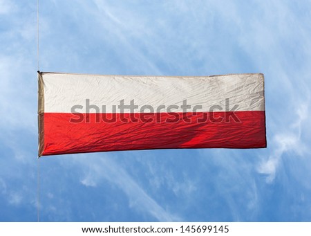 Polish flag in the wind against the sky
