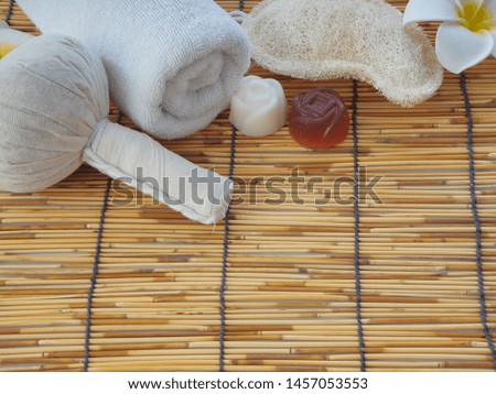 Spa Massage Concept, Herbal Compress Ball, Cream, Flower Soap, Scented Candle on table bamboo