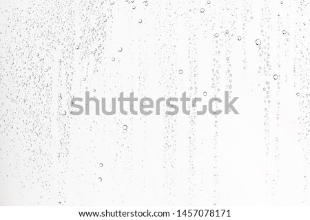 white isolated background water drops on the glass / wet window glass with splashes and drops of water and lime, texture autumn background Royalty-Free Stock Photo #1457078171