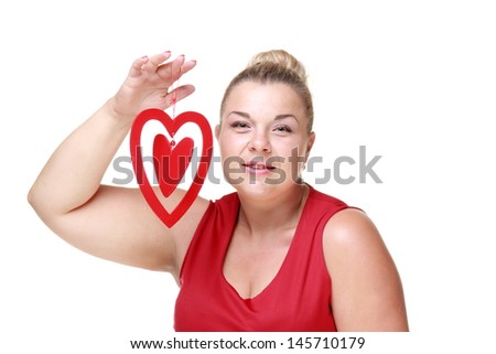 Beautiful european happy woman holding romantic heart symbol