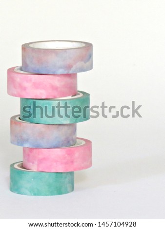 Washi tape rolls, masking tape rolls in pile on white background. Craft supplies DIY Royalty-Free Stock Photo #1457104928