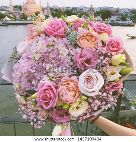 Wedding bouquet of roses. Bride's bouquet on wedding day. Bouquet of different flowers. Bouquet of beautiful pink and white or red roses on the dressing stool. Roses - Image