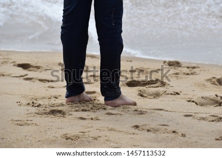 Indian kids and adult playing feet or foot on the beach sand and sea water   Royalty-Free Stock Photo #1457113532