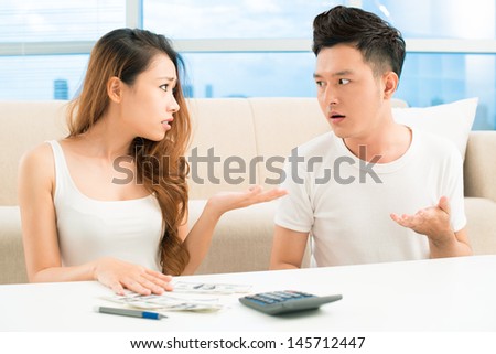 Image of a young couple having a quarrel about money Royalty-Free Stock Photo #145712447