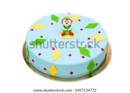 Light blue round cake with a standing clown on top