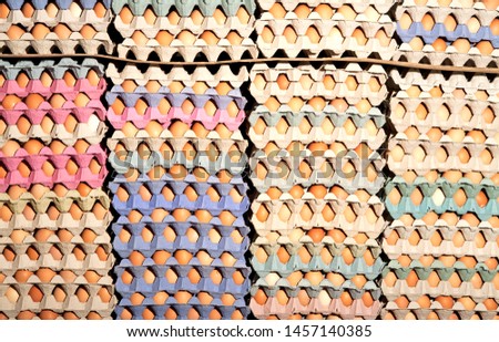 full frame shot of multi-colored free range egg trays cartons and fresh eggs
