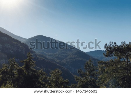 Beautiful landscape in the mountains at sunset. Lovely view of the Taurus Mountains at sunset. Soft sunlight falls on the mountain tops. Kemer, Turkey. Postcard view