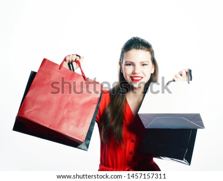 young pretty blond woman posing cheerful isolated on white background with bags on Christmas sale in red dres