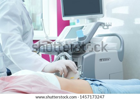 Doctor conducting ultrasound examination of internal organs in clinic, closeup Royalty-Free Stock Photo #1457173247