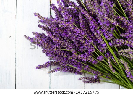 purple lavender flowers heap on faded white wooden table background, directly above