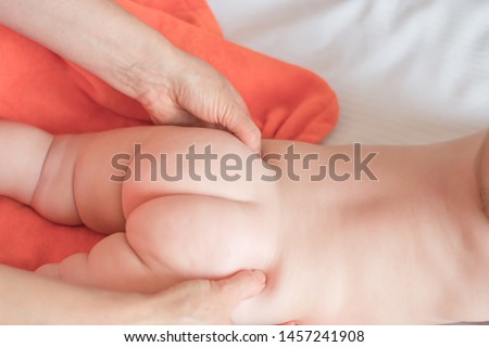 Doctor pediatric terapist a back and lumbar phisical massage to the newborn baby for proper body shaping and body development. Children back massage Royalty-Free Stock Photo #1457241908