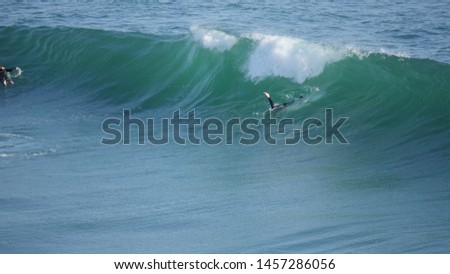 Beach with waves crashing at the ocean with surfer shot in high resolution 4k resolution