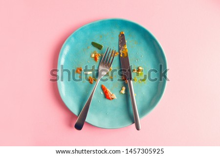 dirty empty plate after scrambled eggs, pasta and vegetarian salad, tasty meal concept Royalty-Free Stock Photo #1457305925