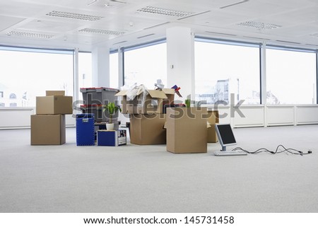 Cartons and equipment on floor of empty office space Royalty-Free Stock Photo #145731458
