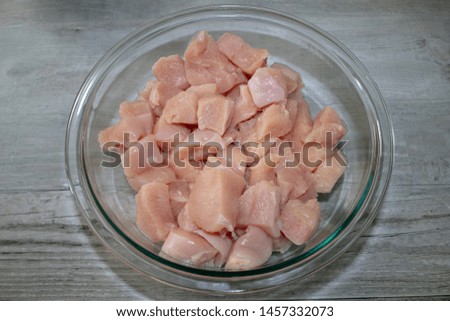 Bowl with chicken cut in small pieces.