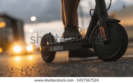 Young man at night with electric scooter or e-scooter in the city, Electric urban transportation concept image Royalty-Free Stock Photo #1457367524