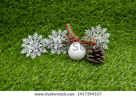 Golf Christmas with golf ball and snowflake on green grass