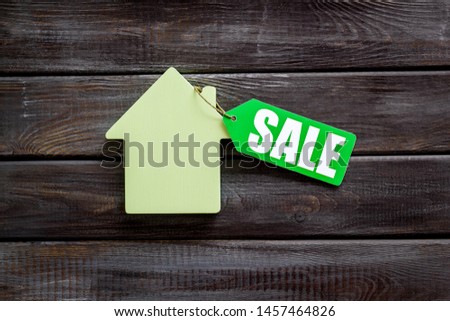 Sale for house with lable and figure on wooden background top view