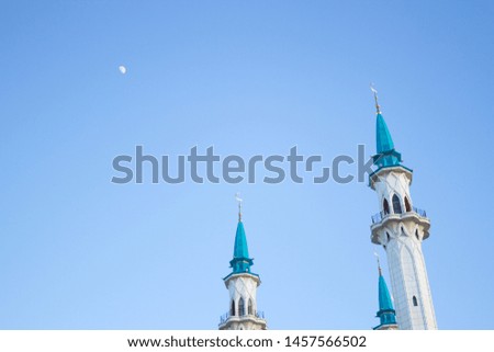 big white mosque with blue roof