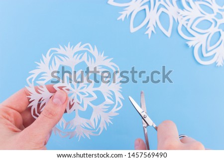 snowflakes made of paper on the blue background