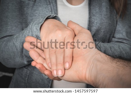 Two pairs of hands touch each other - together, helping, support, sympathy, empathy concept