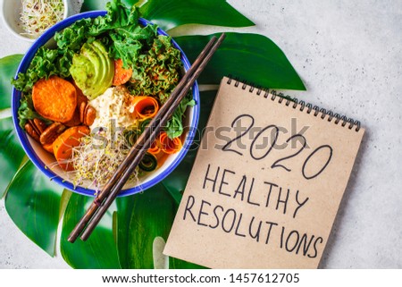 Healthy vegan lunch in a white bowl. Buddha bowl with avocados, sweet potatoes, sprouts and vegetables. Royalty-Free Stock Photo #1457612705