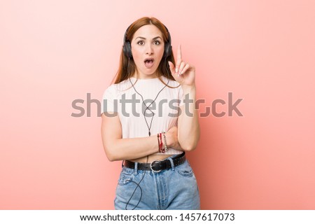 Young caucasian woman listen to music having some great idea, concept of creativity.