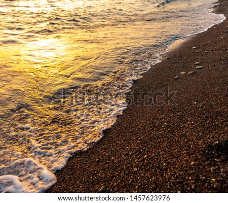 Waves on the seashore at sunset.
