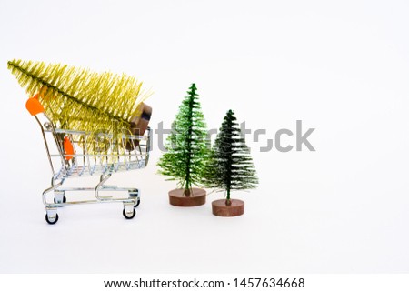 decorative Christmas tree in a shopping cart on a white background, copy space