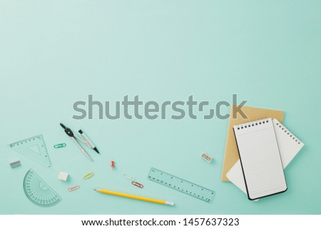 Creative arrangements of stationery on pastel pale blue background. Top view or flat lay. Education concept. Office desk with copy space.