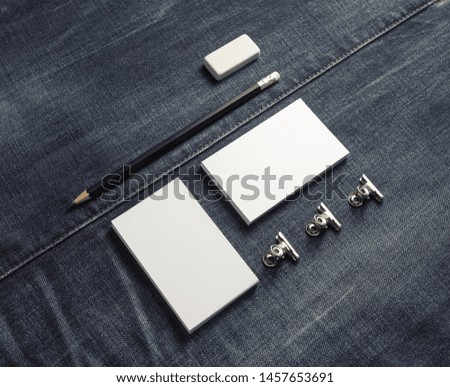 Photo of blank business stationery set on denim background.