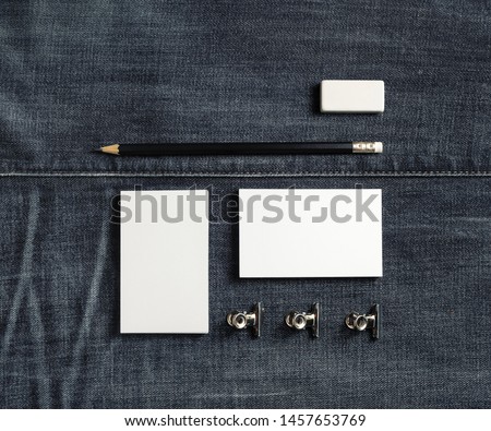 Photo of blank stationery set on denim background. Copy space for text. Flat lay.