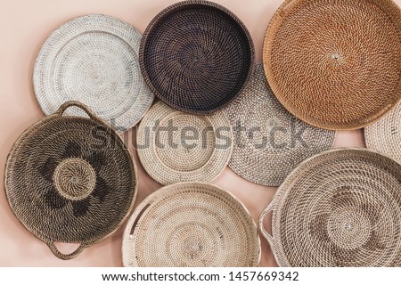 Wall decorated with different wicker handmade trays and baskets. Eco style and concept, Moroccan culture.