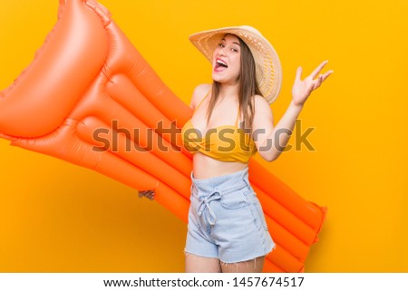 Young caucasian woman holding a floater